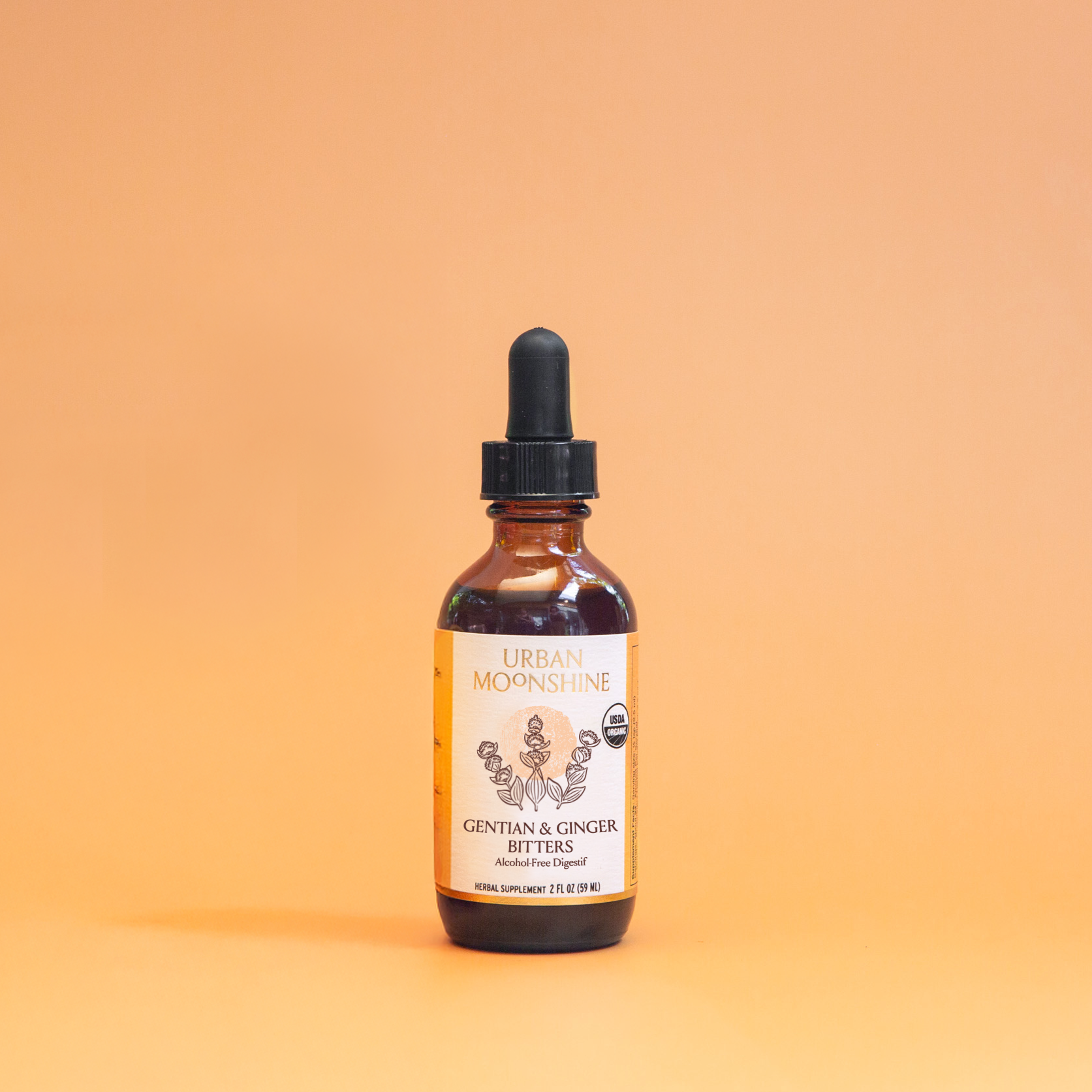 Bottle of organic gentian & ginger bitters on a gradient orange background