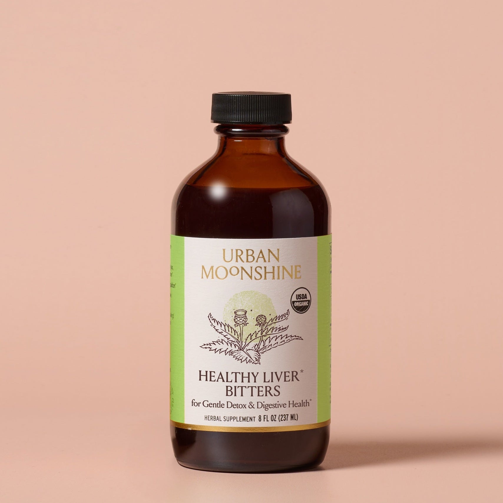 Bottle of Urban Moonshine Healthy Liver Bitters on a beige background